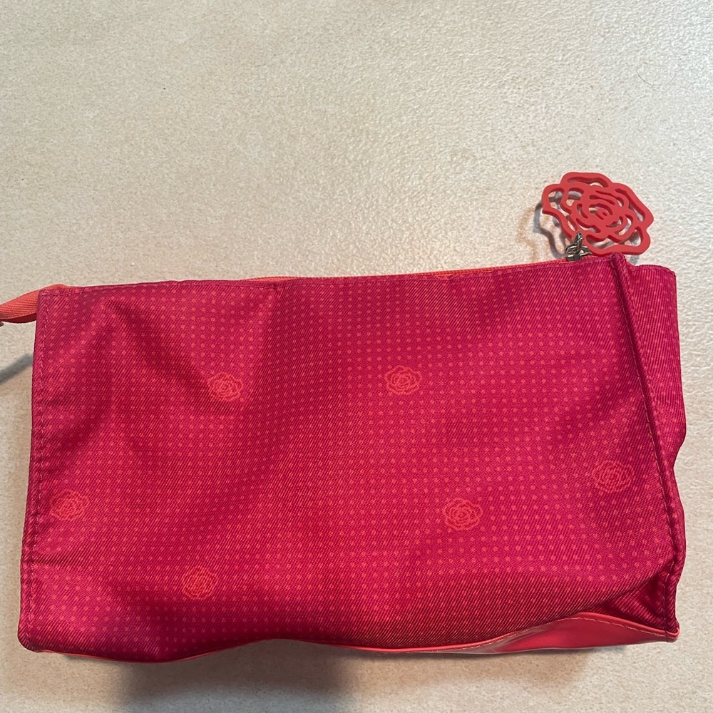 Pink Lancôme make up bag with brush and samples